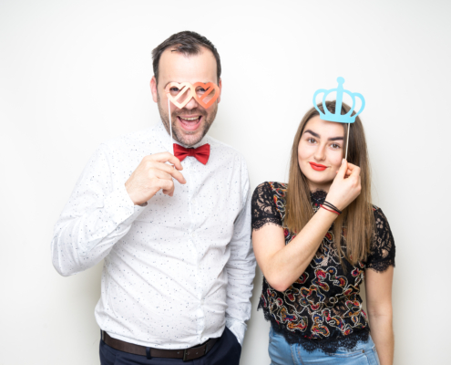 young couple posing wedding photo booth props happy smile plain